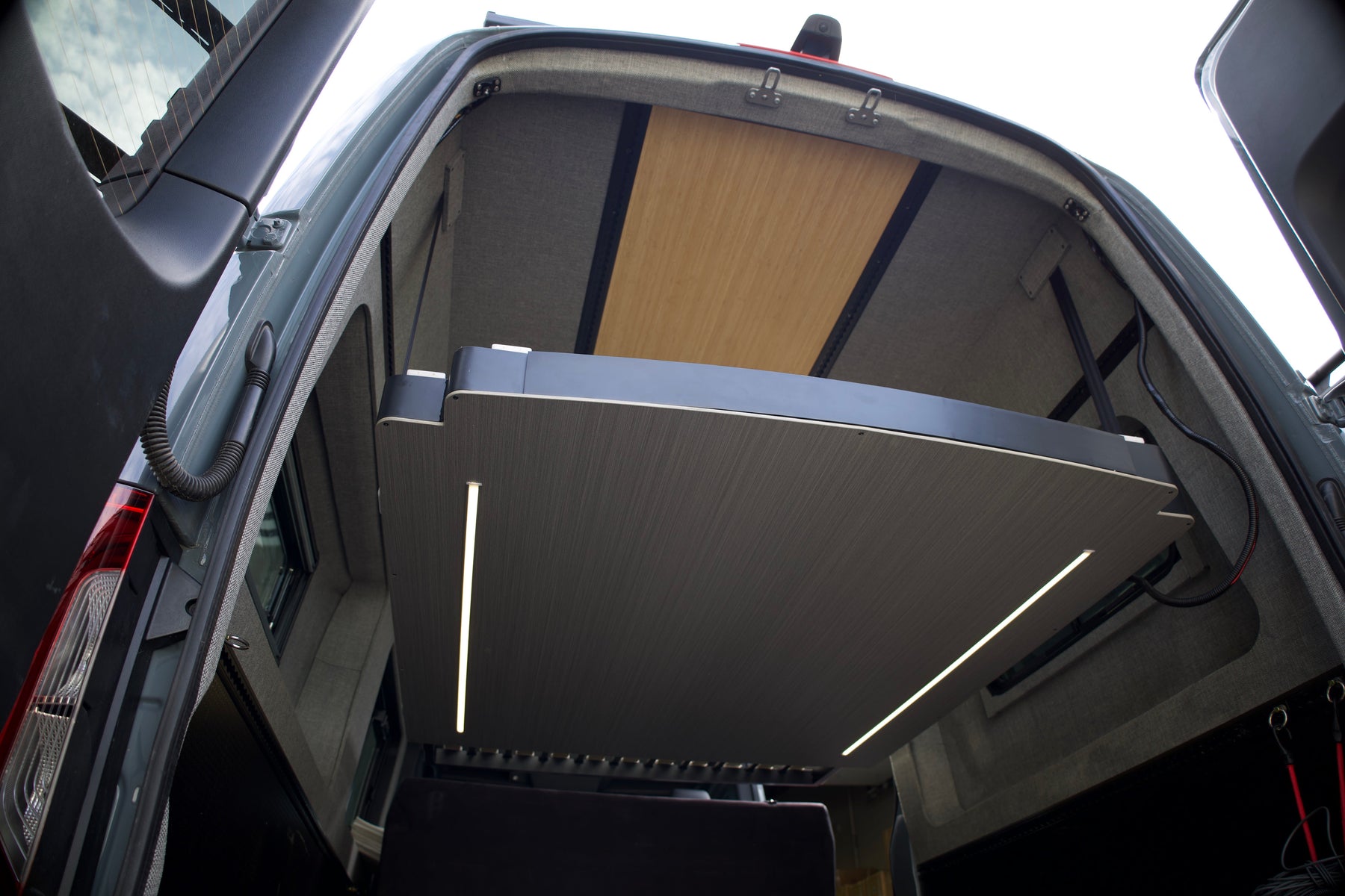 RoamLabX elevator bed lowered inside a finished camper van
